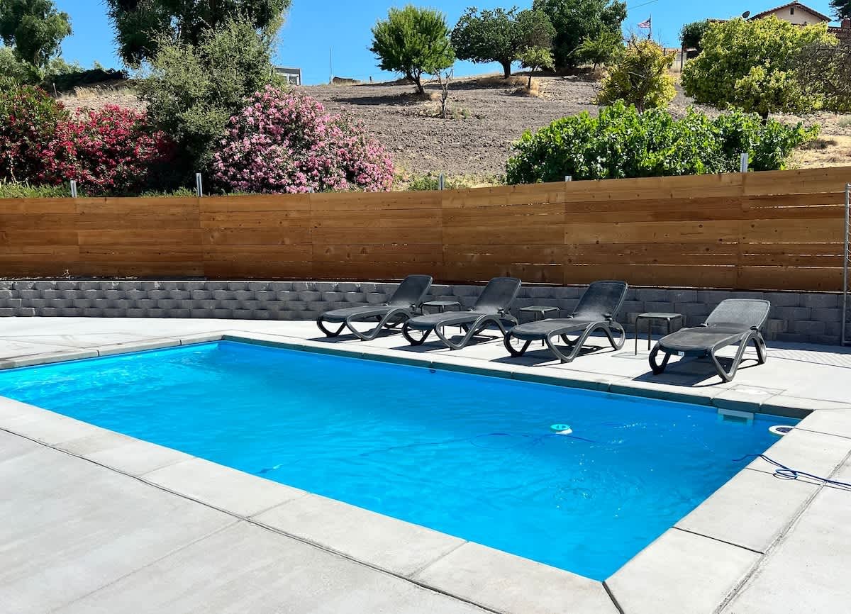 Swimming pool and loungers at Paso Panorama, a hilltop vacation rental in Paso Robles wine country