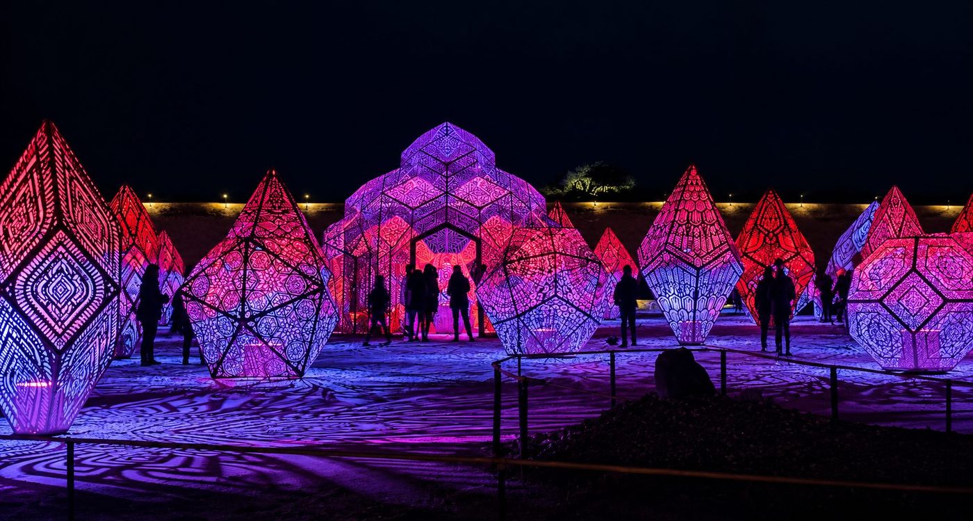 Glowing pink and purple geometric light sculptures at night at Sensorio, Paso Robles