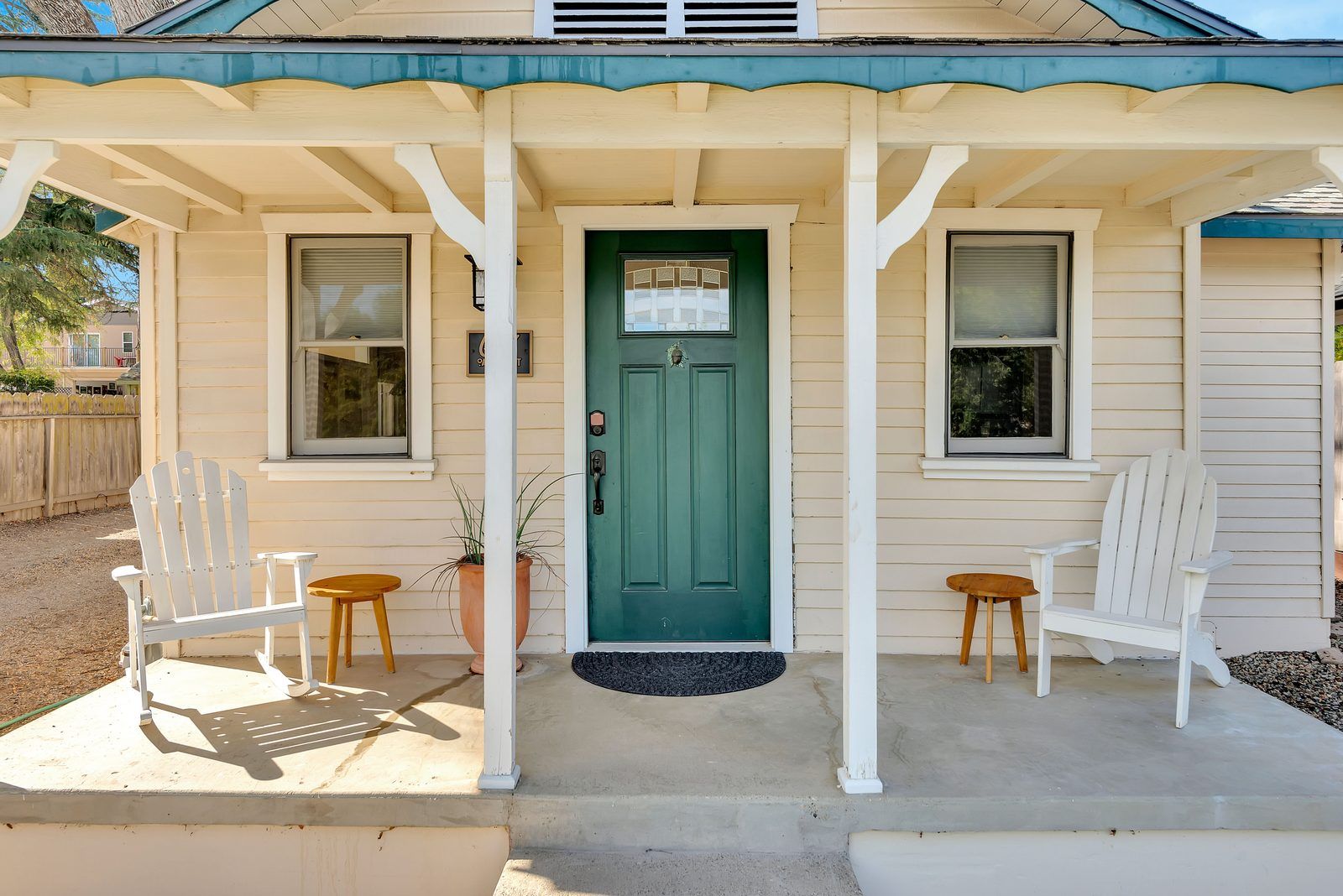 Covered front porch with Adirondack chairs at Under the Oaks, a 1918 Craftsman vacation rental on Oak Street in Paso Robles