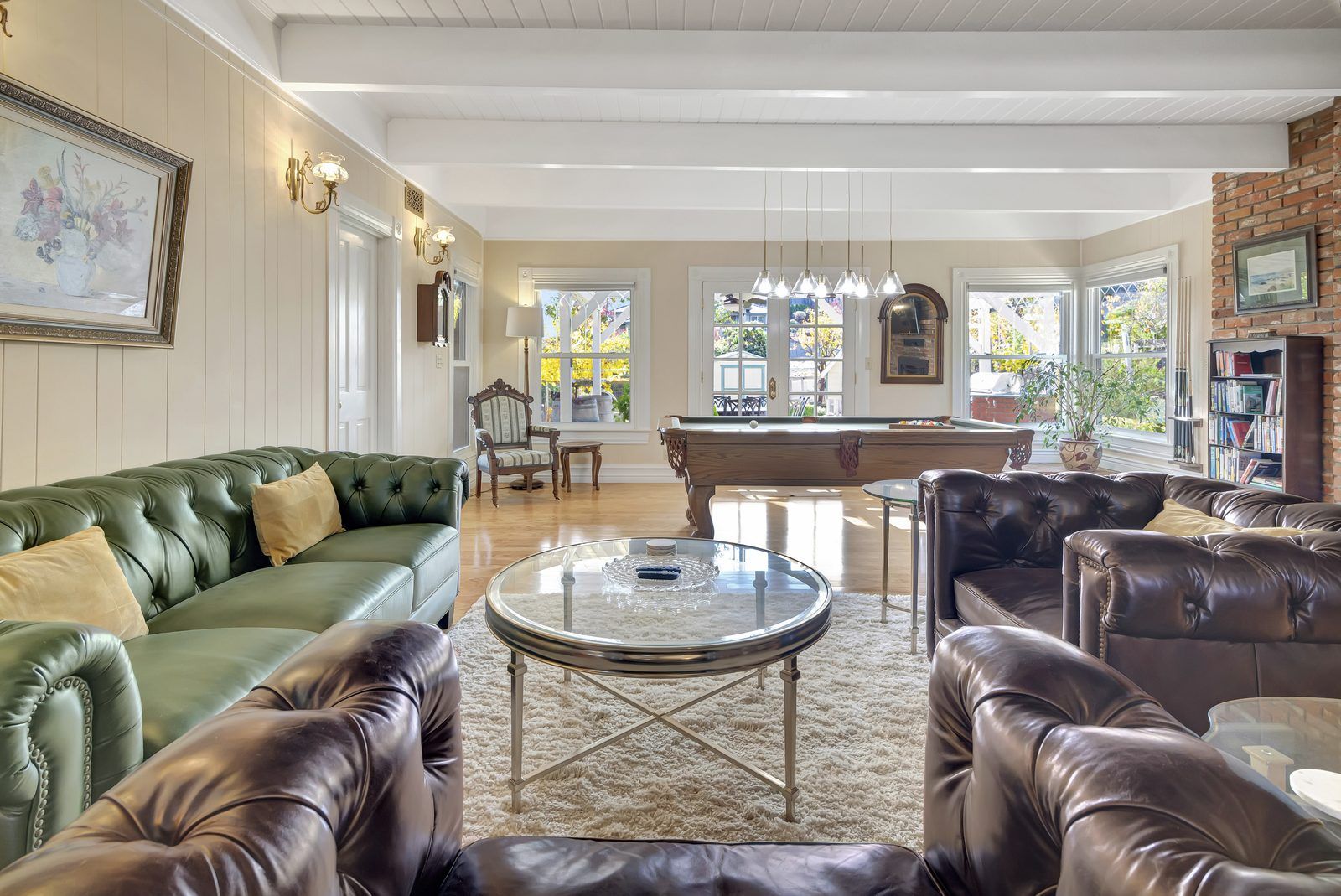 Great room with pool table and leather chesterfields at Victorian Villa, an 1872 historic vacation rental in downtown Paso Robles